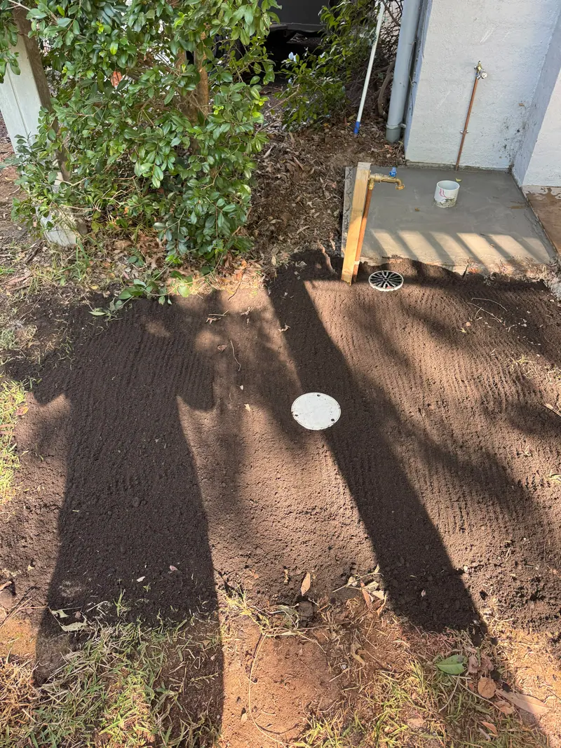 Finished ground surface around a gully grate and inspection cover