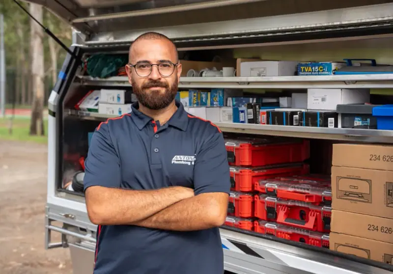 Antons technician beside a stocked plumbing service vehicle